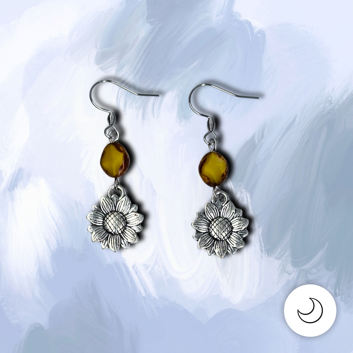 Handmade sunflower drop earrings with yellow and brown Picasso glass beads, silver-tone floral charms, and hypoallergenic surgical steel ear wires.