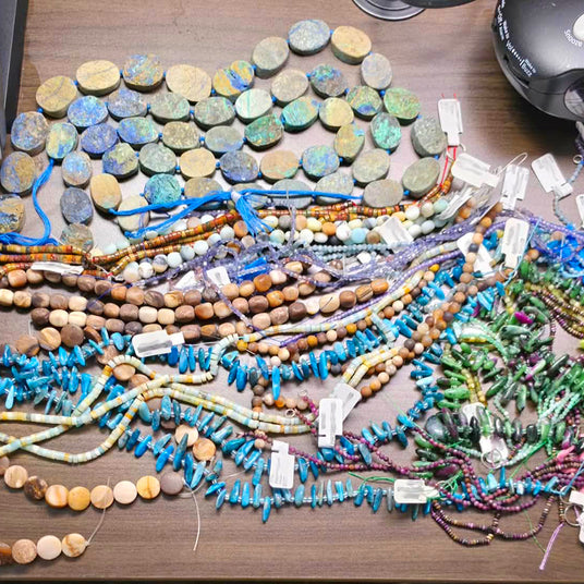 A selection of beads on strings purchased by Designed by Distraction for the purpose of designing and building new handmade, artisan jewelry