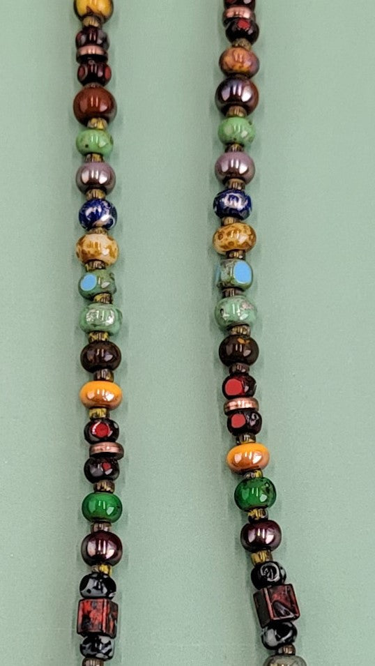 Handmade Boho necklace featuring a rustic antiqued copper sea star and an array of bright Picasso glass beads in multiple colors. Coastal-inspired artisan jewelry for a touch of seaside elegance.