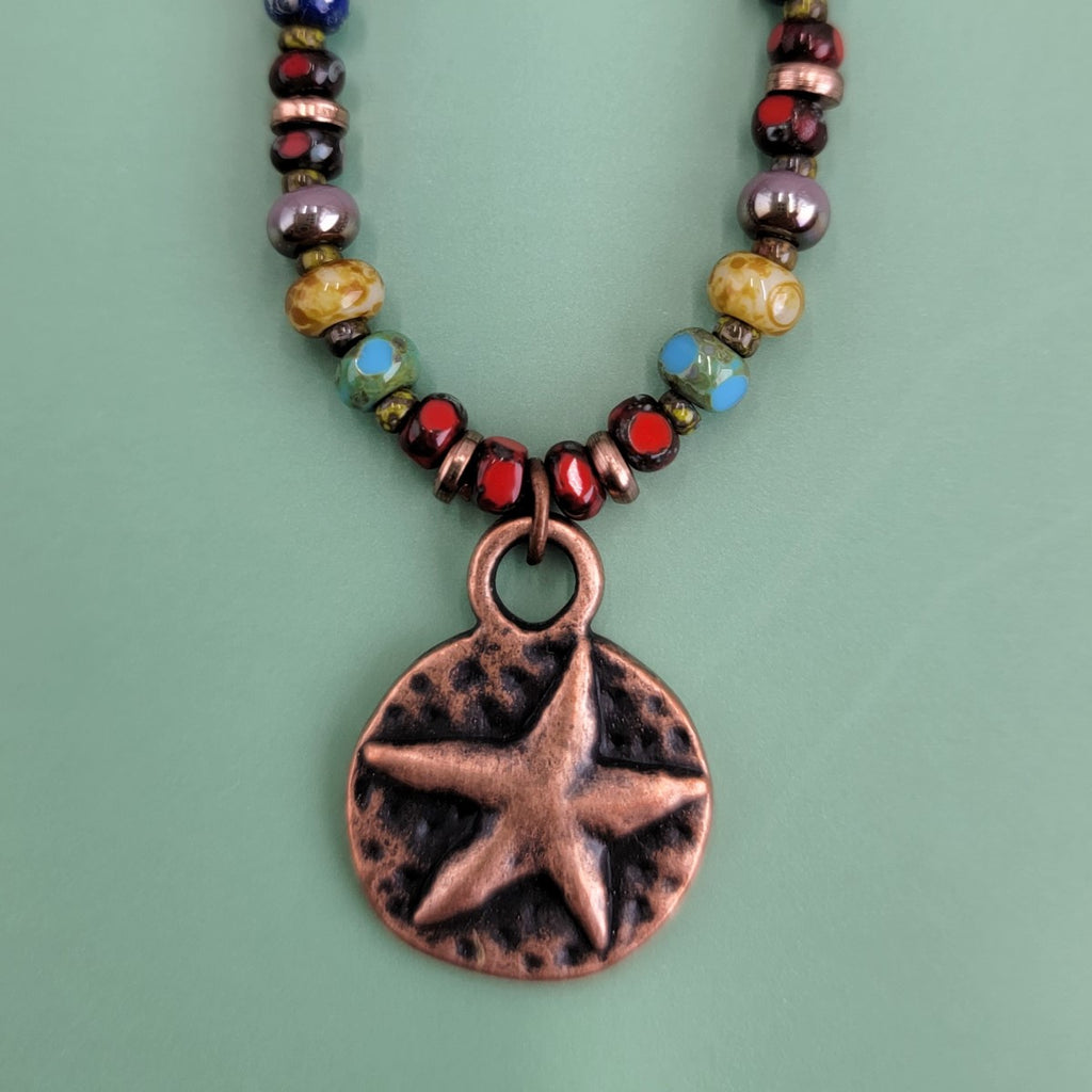 Handmade Boho necklaces with rustic antiqued copper sea star and lots of bright Picasso glass in multiple colors