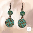 A sunburst medallion washed in verdigris patina hangs beneath a faceted aqua Picasso glass bead, all on hypoallergenic niobium hooks. They’re earthy, a little old-world, and easy to wear every day. 1 5/8" long.