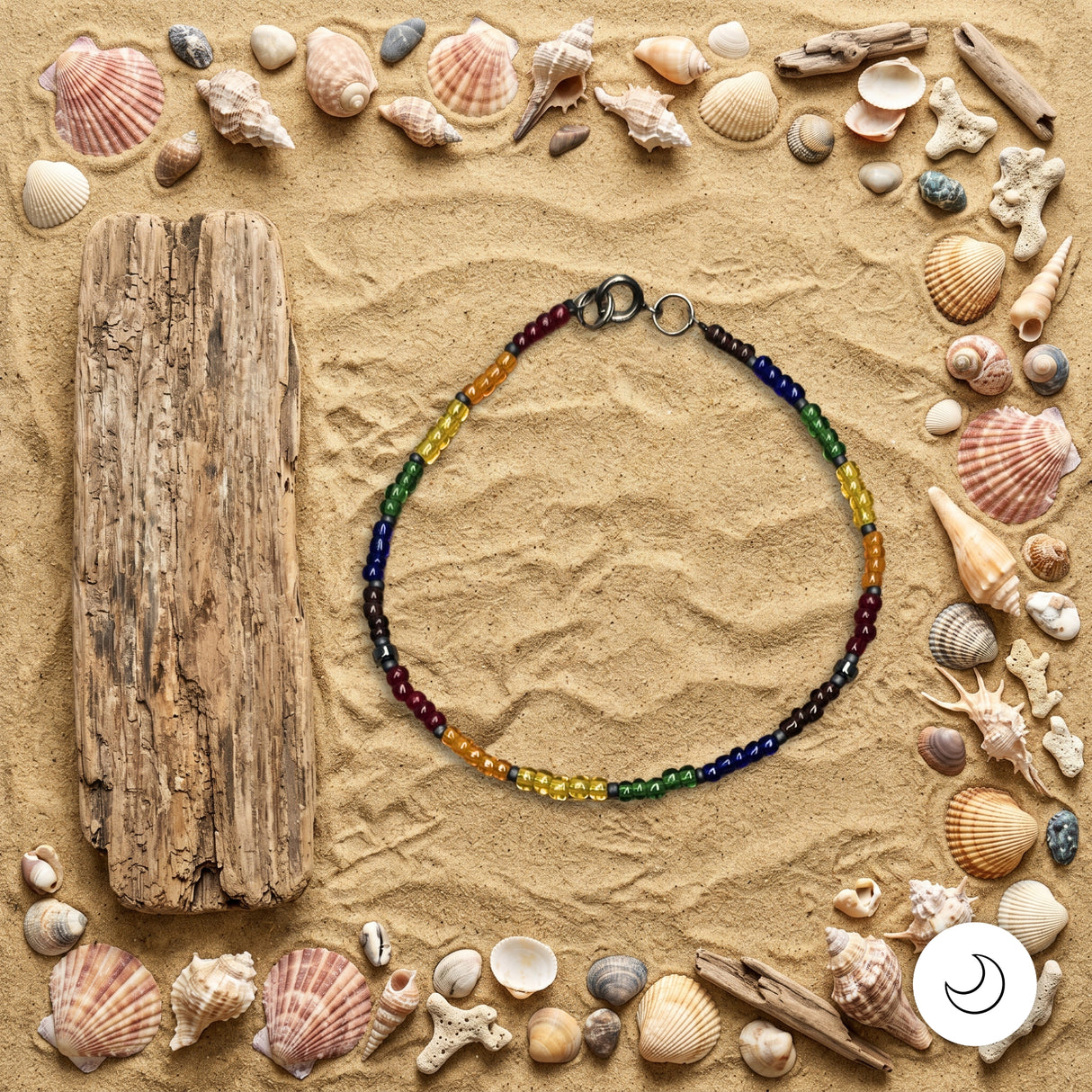 Pride rainbow beaded necklace on background of sand with seashells and driftwood