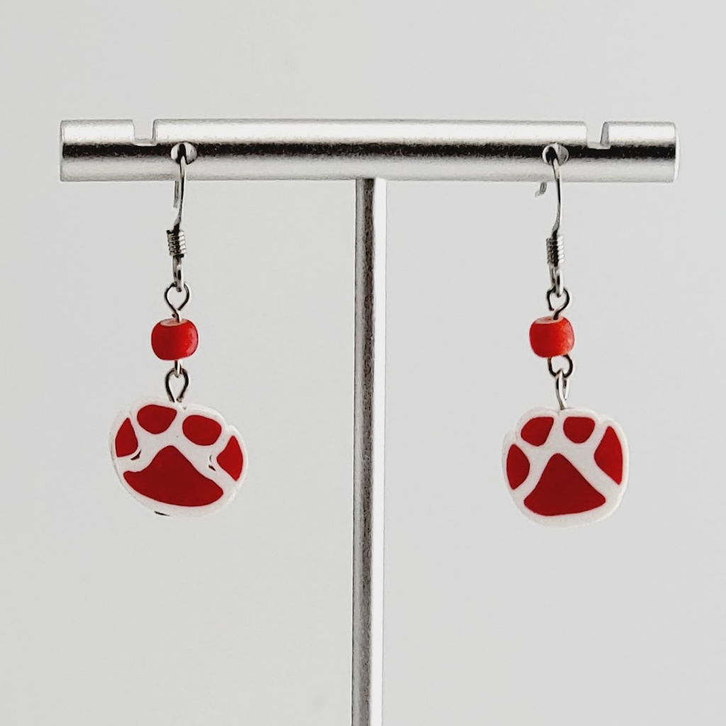 Handmade, hypoallergenic earrings with red paw prints on white polymer clay and accented with red Czech glass beads 