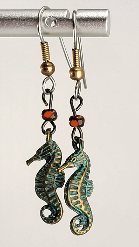 Handmade, hypoallergenic earrings with tiny green seahorses and red Picasso glass beads 