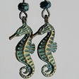Tiny green seahorse earrings with dark green Picasso glass beads