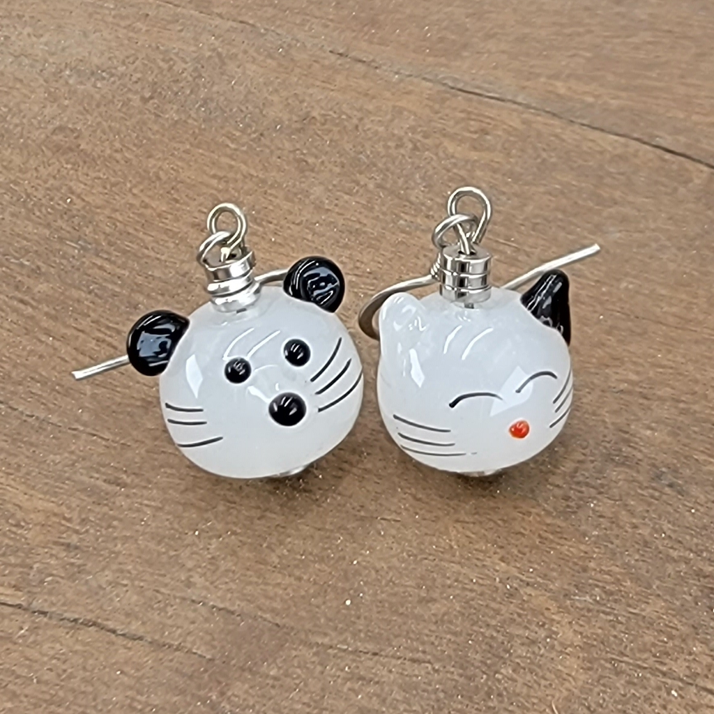 Hypoallergenic handmade cat and mouse earrings. These mismatched cuties include anime-inspired cat and mouse on white glass with painted features.