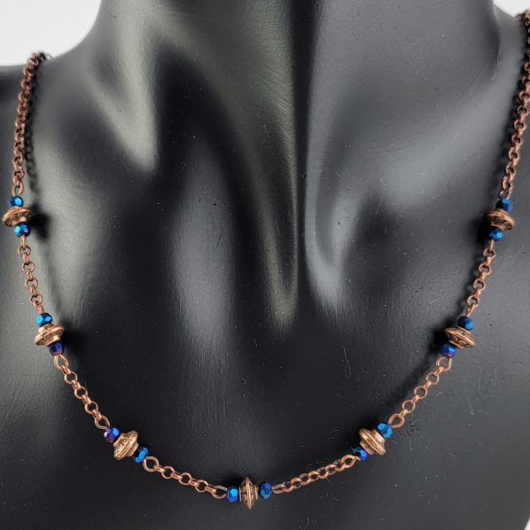 Handmade necklace with copper saucer beads and bright blue faceted Czech glass beads