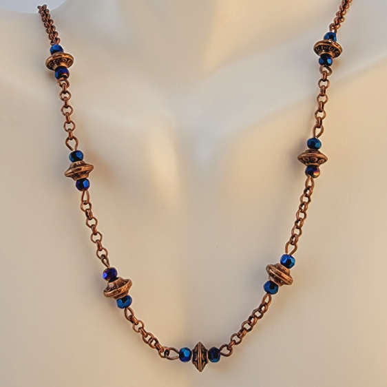 Handmade necklace with copper saucer beads and bright blue faceted Czech glass beads