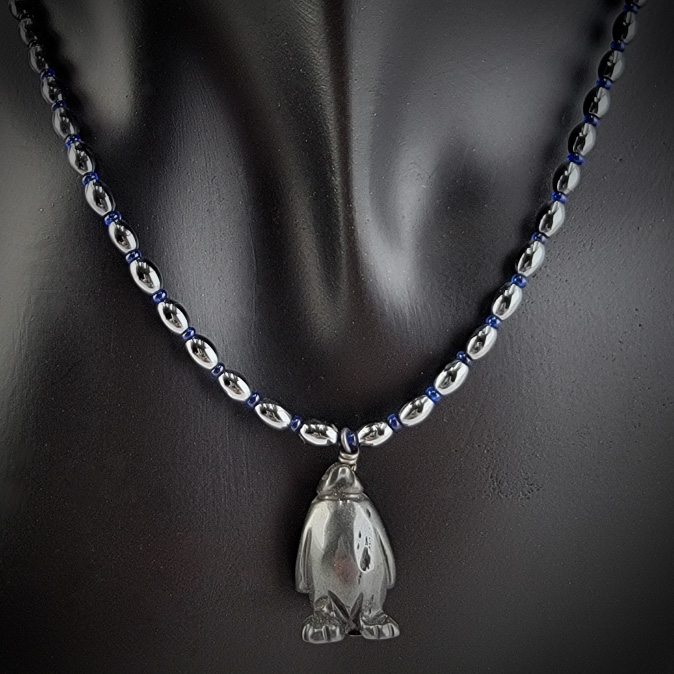 Handmade necklace with hematite penguine pendant, hematite rice beads, and cobalt blue Czech glass beads