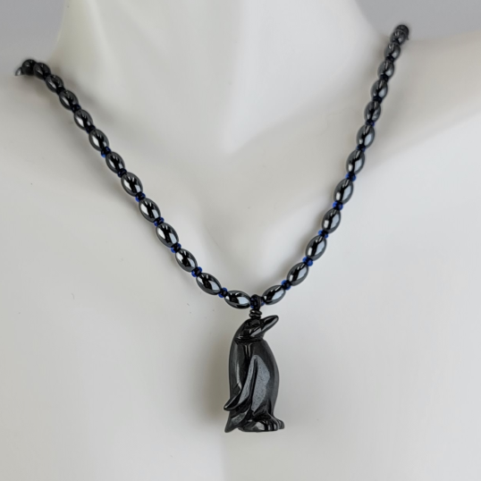 Handmade necklace with hematite penguine pendant, hematite rice beads, and cobalt blue Czech glass beads