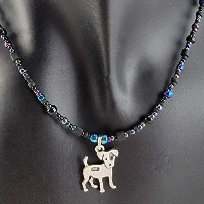 Handmade beaded necklace with pewter happy spotted dog pendant and black, grey, and irridescent blue beads