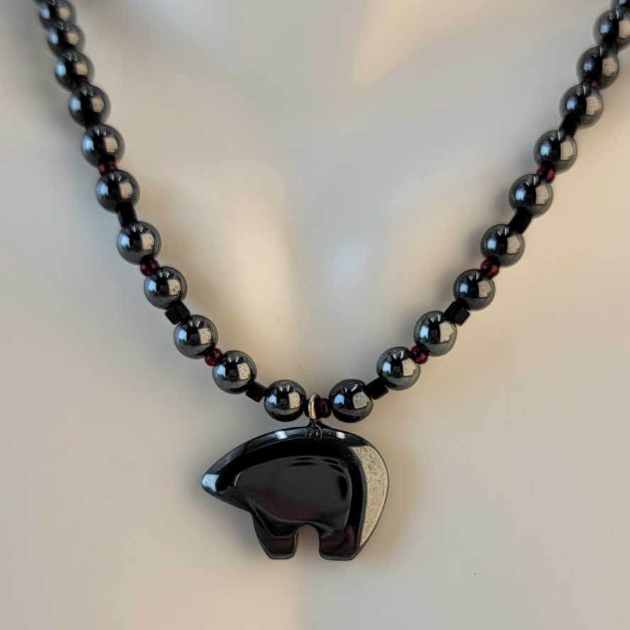 Handmade necklace with hematitve bear, hematite beads, and black and dark red accent beads