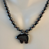 Handmade necklace with hematitve bear, hematite beads, and black and dark red accent beads