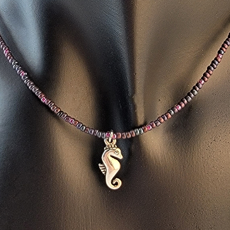 Handmade beaded necklace with pewter seahorse pendant and plum and blue beads 
