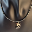 Handmade necklace with pendant of a wolf howling at the moon and hematite and small gold filled beads