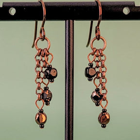 Handmade Boho style earrings. Petite, triple drops, with copper and black Czech glass hanging from antiqued copper chain. Hypoallergenic niobium ear wires. Total earring length is 1 1/2".