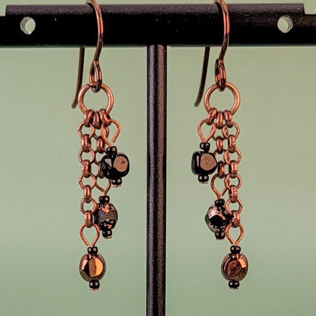 Handmade Boho style earrings. Petite, triple drops, with copper and black Czech glass hanging from antiqued copper chain. Hypoallergenic niobium ear wires. Total earring length is 1 1/2".