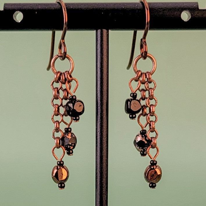 Handmade Boho style earrings. Petite, triple drops, with copper and black Czech glass hanging from antiqued copper chain. Hypoallergenic niobium ear wires. Total earring length is 1 1/2".