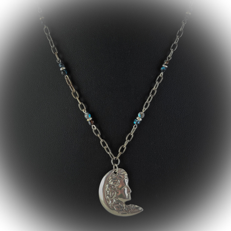 Handmade necklace with a pewter lady moon pendant, blue agate beads, and silver disks on gunmetal chain