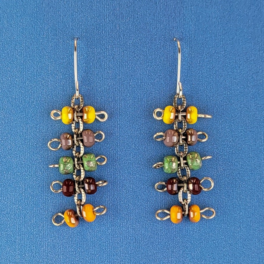 Handmade quirky Boho earrings with five layers of colorful Picasso glass bead barbells. Hypoallergenic stainless steel ear wires. Total earring length is 2 1/8".