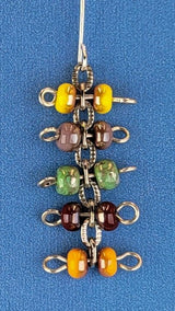 Handmade quirky Boho earrings with five layers of colorful Picasso glass bead barbells. Hypoallergenic stainless steel ear wires. Total earring length is 2 1/8".