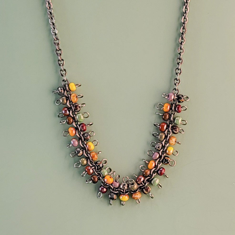 Handmade boho necklace with richly-colored Picasso glass beads on a gunmetal rolo-style chain