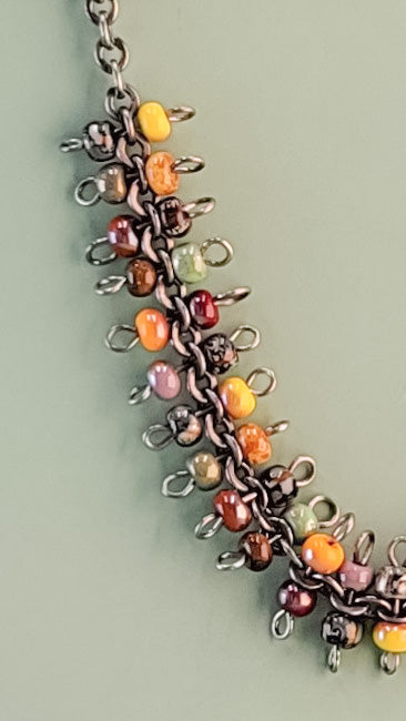 Handmade boho necklace with richly-colored Picasso glass beads on a gunmetal rolo-style chain