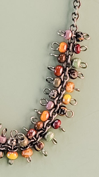 Handmade boho necklace with richly-colored Picasso glass beads on a gunmetal rolo-style chain
