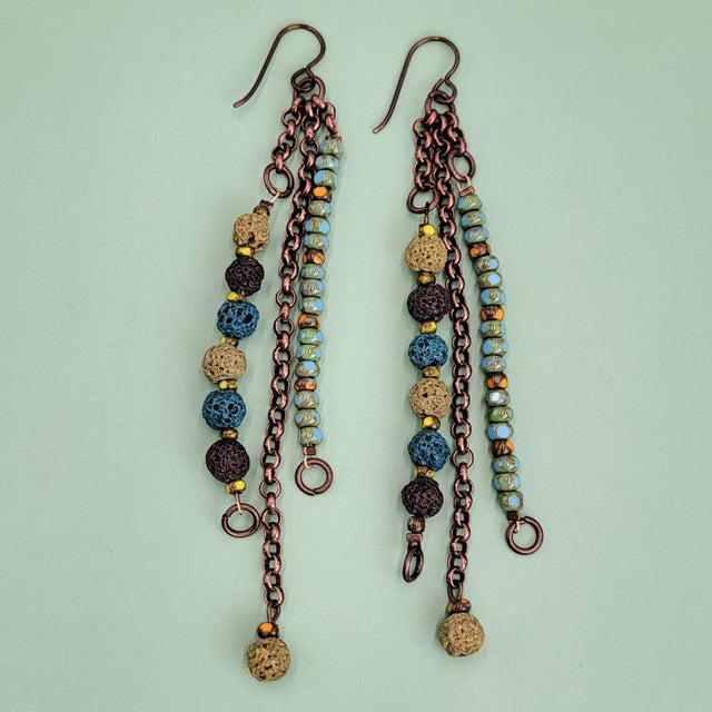 Handmade Boho earrings, triple drop, with lava beads dyed in browns and greens, along with turquoise Picasso glass and antiqued copper chain.
