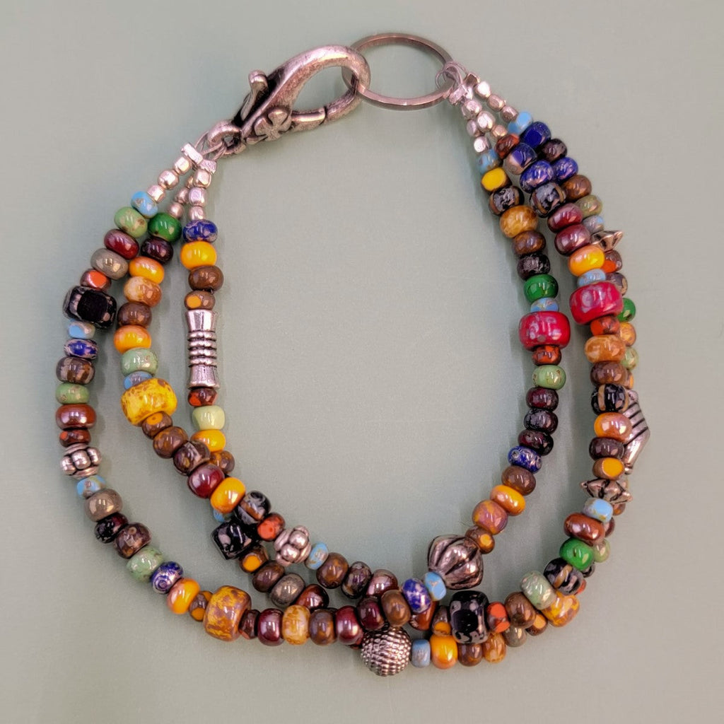 Handmade three-layered Boho bracelet with Picasso glass beads in a multitude of colors along with Pewter accents and a large, easy-to-close clasp.