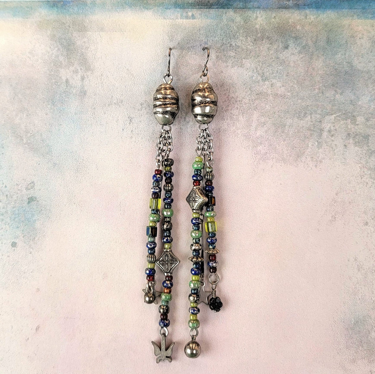 Dangly handmade Boho earrings, triple drops, dazzling blues, greens, and silver. 4 3/4" long, hypoallergenic ear wires. 