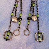 Handmade Boho earrings on gunmetal chain with bright green cubes and Picasso glass, metallic puff circles and hollow squares. 