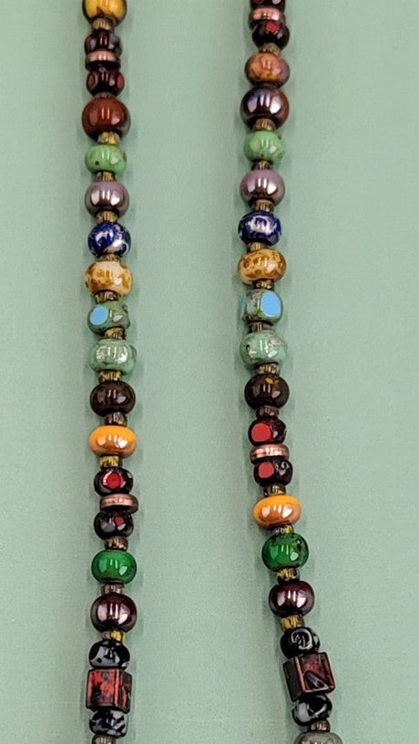 Handmade Boho necklace featuring a rustic antiqued copper sea star and an array of bright Picasso glass beads in multiple colors. Coastal-inspired artisan jewelry for a touch of seaside elegance.