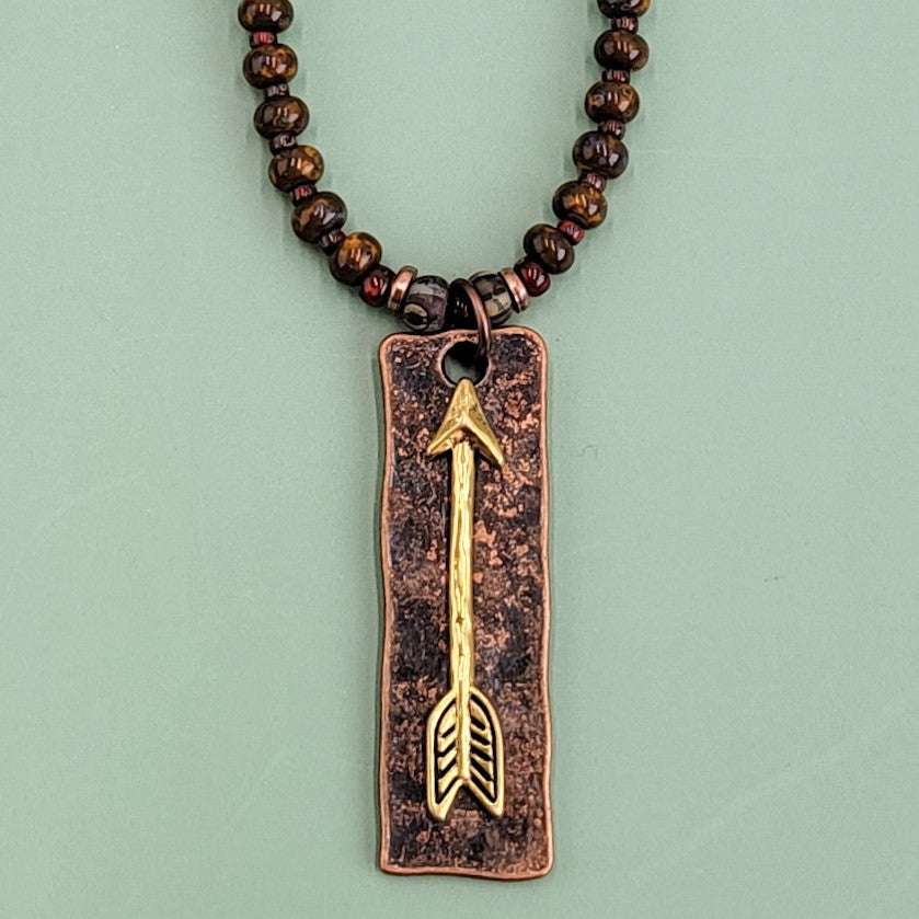 Handmade Boho necklace with rustic arrowhead and Picasso glass in rich browns and reds. 
