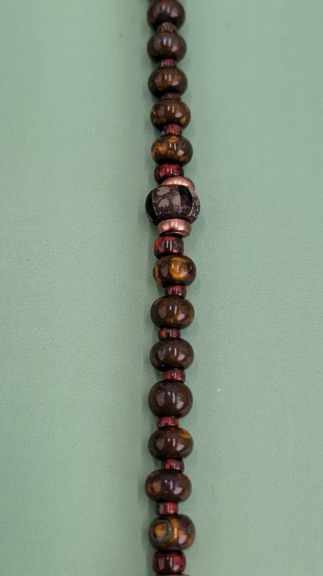 Handmade Boho necklace with rustic arrowhead and Picasso glass in rich browns and reds. 