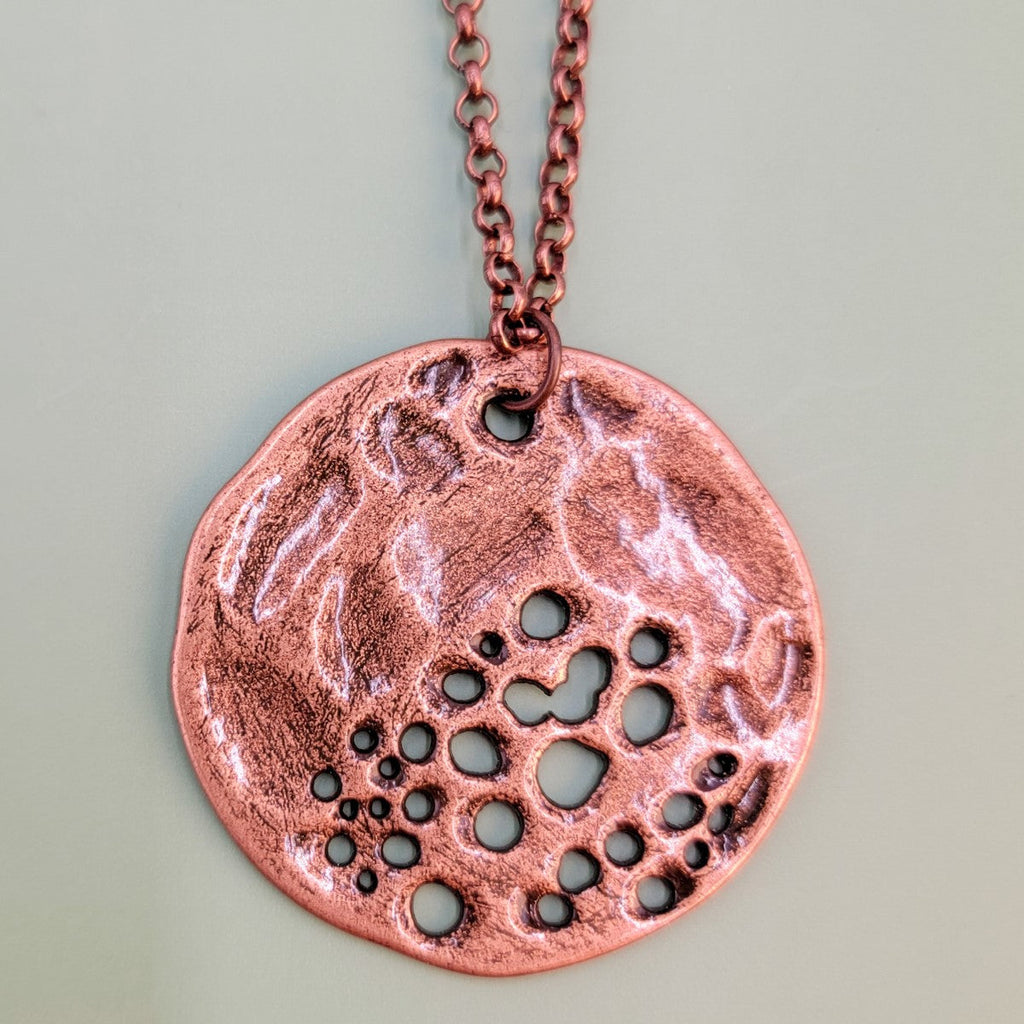 Handmade Boho necklace with large cratered moon in antiqued copper on an antiqued copper chain