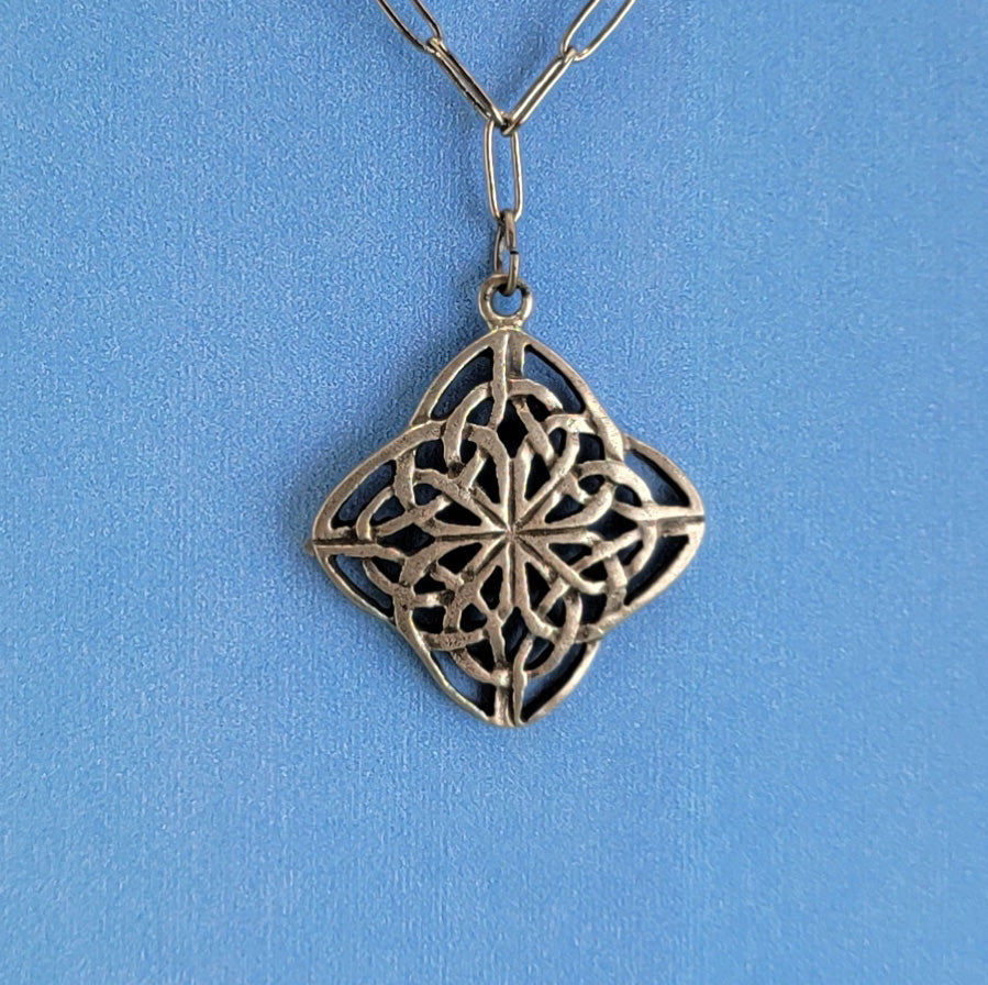 Handmade Boho necklace with pewter Celtic diamond knot and hung on a gunmetal chain