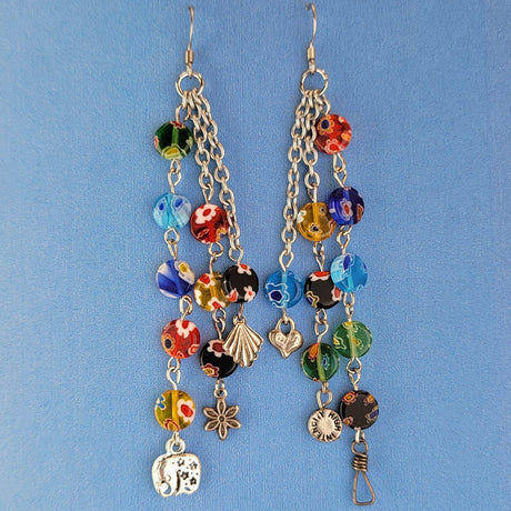 These handmade Boho earrings have African glass flower beads in a variety of colors and designs, along with an eclectic mix of pewter and antiqued silver charms. The ear wires are hypoallergenic surgical steel. Total earring length is 4".