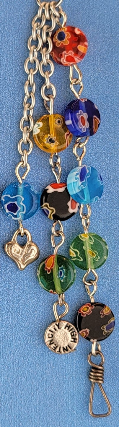 These handmade Boho earrings have African glass flower beads in a variety of colors and designs, along with an eclectic mix of pewter and antiqued silver charms. The ear wires are hypoallergenic surgical steel. Total earring length is 4".