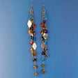 These handmade Boho earrings have African glass flower beads in a variety of colors and designs, along with an eclectic mix of pewter and antiqued silver charms. The ear wires are hypoallergenic surgical steel. Total earring length is 6".