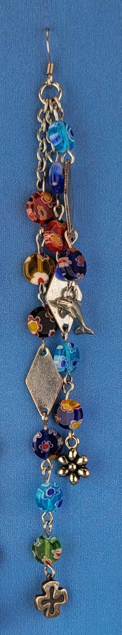 These handmade Boho earrings have African glass flower beads in a variety of colors and designs, along with an eclectic mix of pewter and antiqued silver charms. The ear wires are hypoallergenic surgical steel. Total earring length is 6".