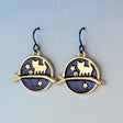 Hypoallergenic handmade cat earrings including gold cat on a branch with blue enamel background and stars