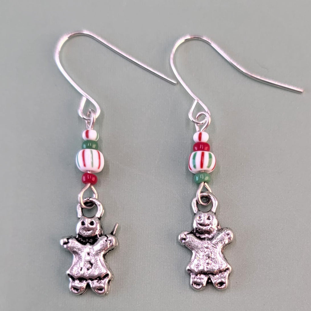 Hypoallergenic gingerbread man earrings with peppermint-striped beads