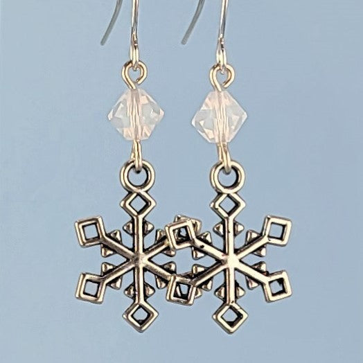 Handmade hypoallergenic geometric snowflake earrings with snowy white beads, lead-free pewter