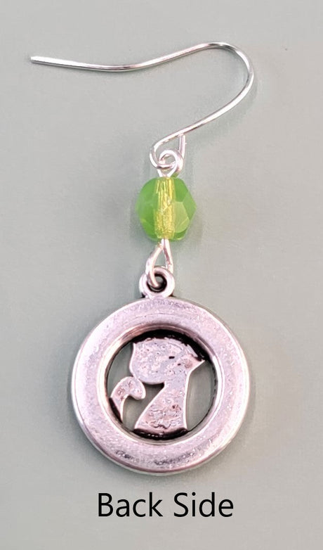 Hypoallergenic silver cat earrings have hammered silver rings with sweet smiling kittens and green Czech glass accent beads