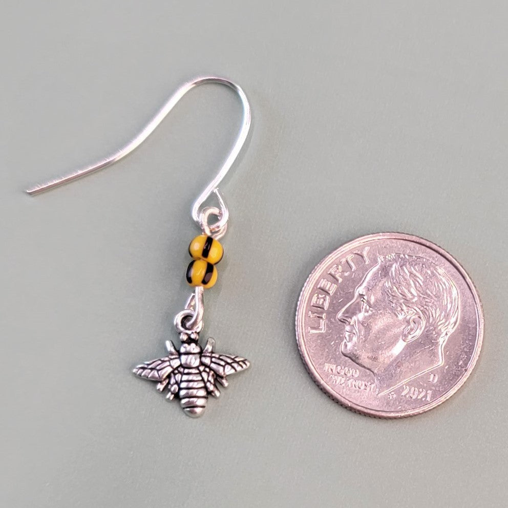 Handmade hypoallergenic bee earrings, each with two yellow and black glass beads