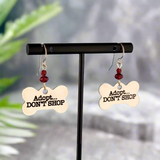 Hypoallergenic adopt don't shop earrings with bone-shaped charms and red Picasso glass