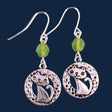 Hypoallergenic silver cat earrings have hammered silver rings with sweet smiling kittens and green Czech glass accent beads